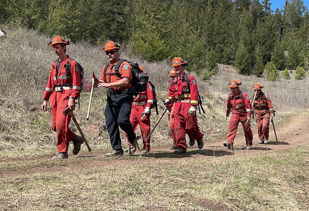 default-410 A group of firefighters walk in a line during a sunny day.